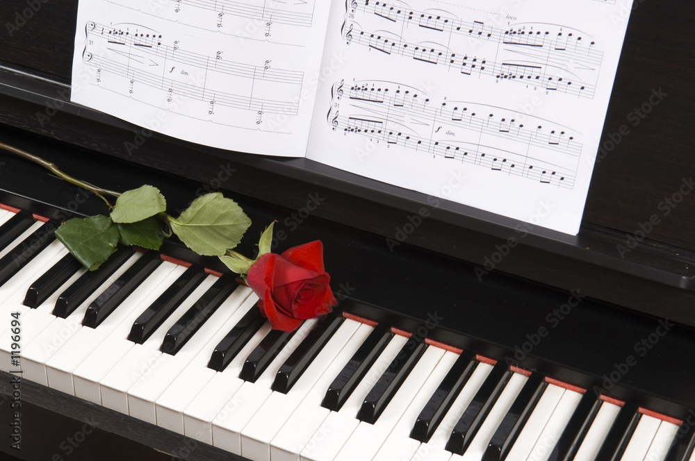 sheet music with rose on piano