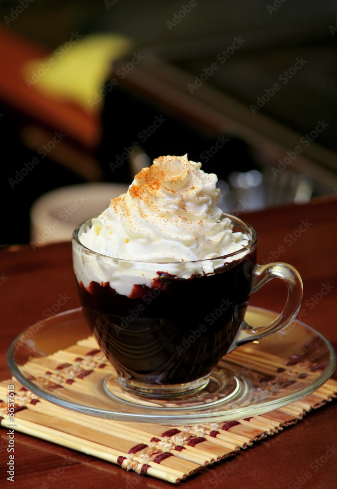 Hot chocolate with whipping cream in cafe