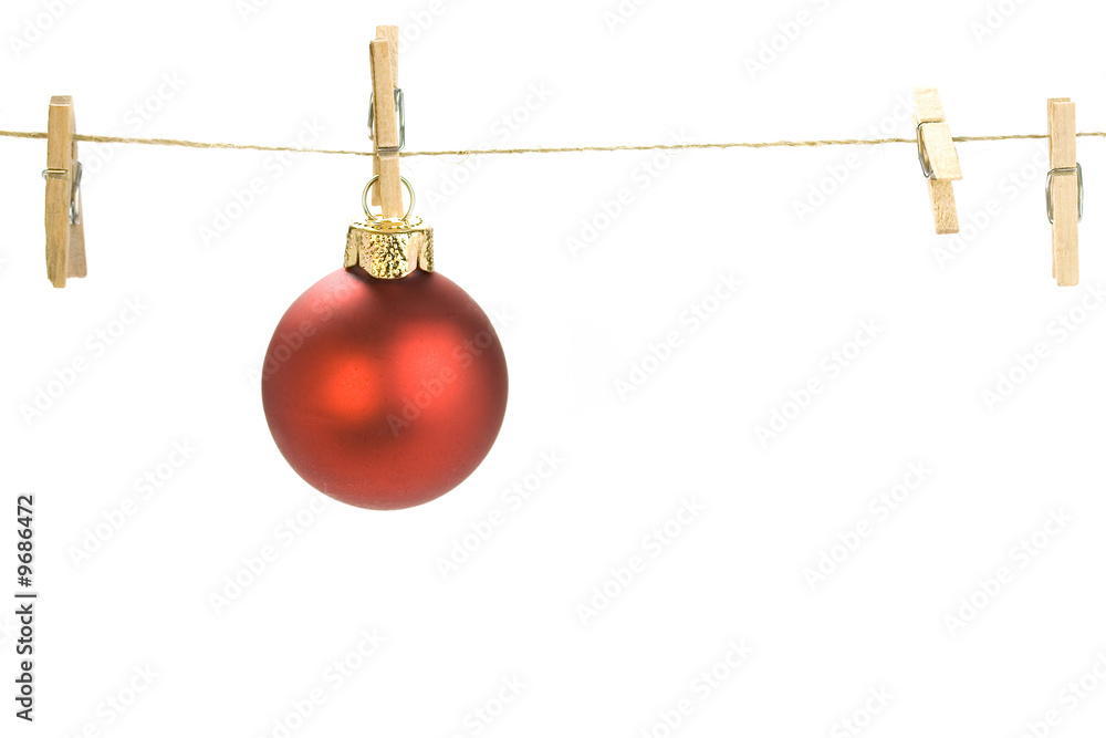 Christmas ball on clothes line. White background