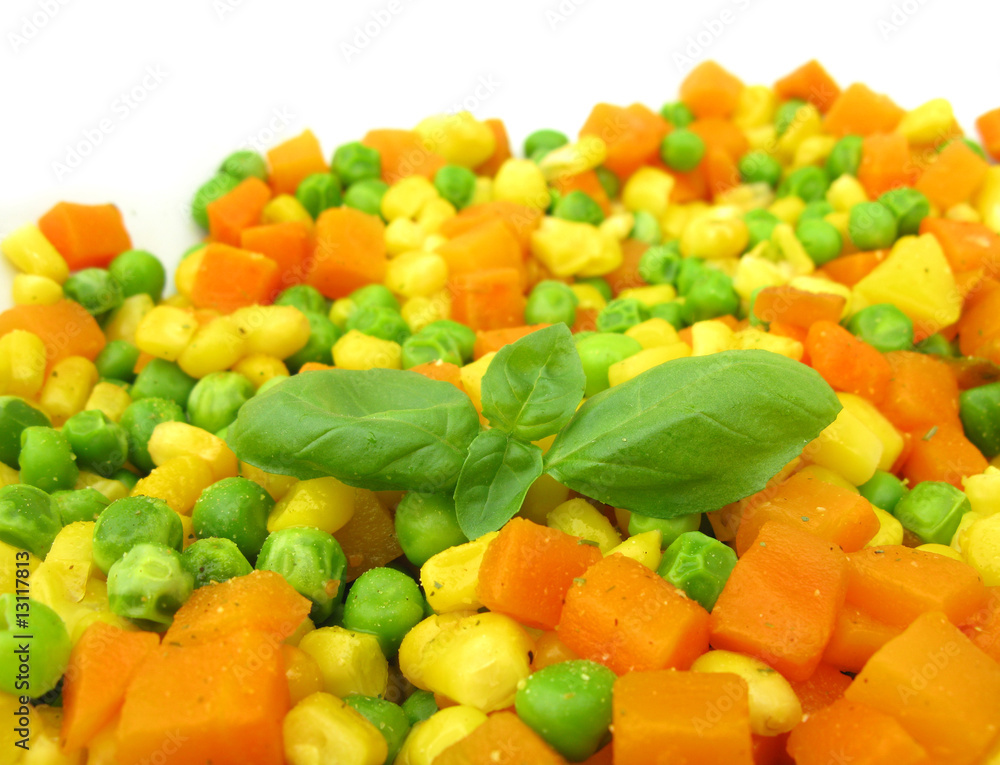 Cooked vegetables with basil leaves