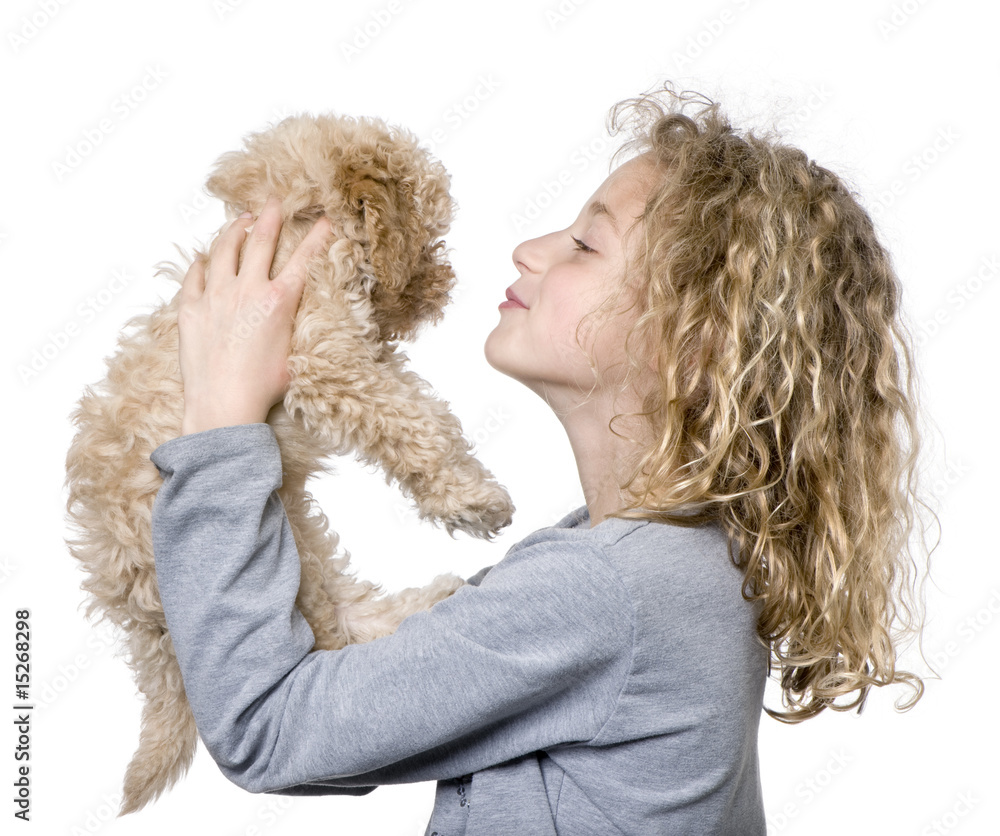 Young girl with her toy Poodle puppy (9 weeks old)