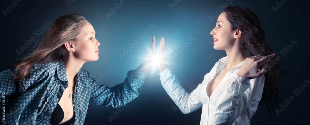 Two young women stretching hands