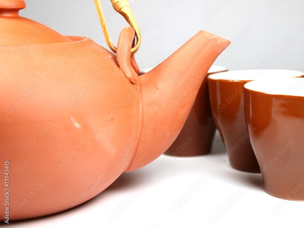 ceramic chinese teapot with tea cups on white background