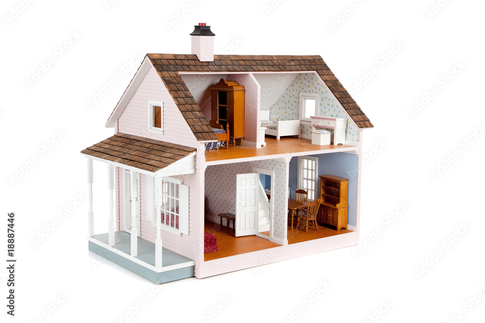 Furnished pink doll house on white