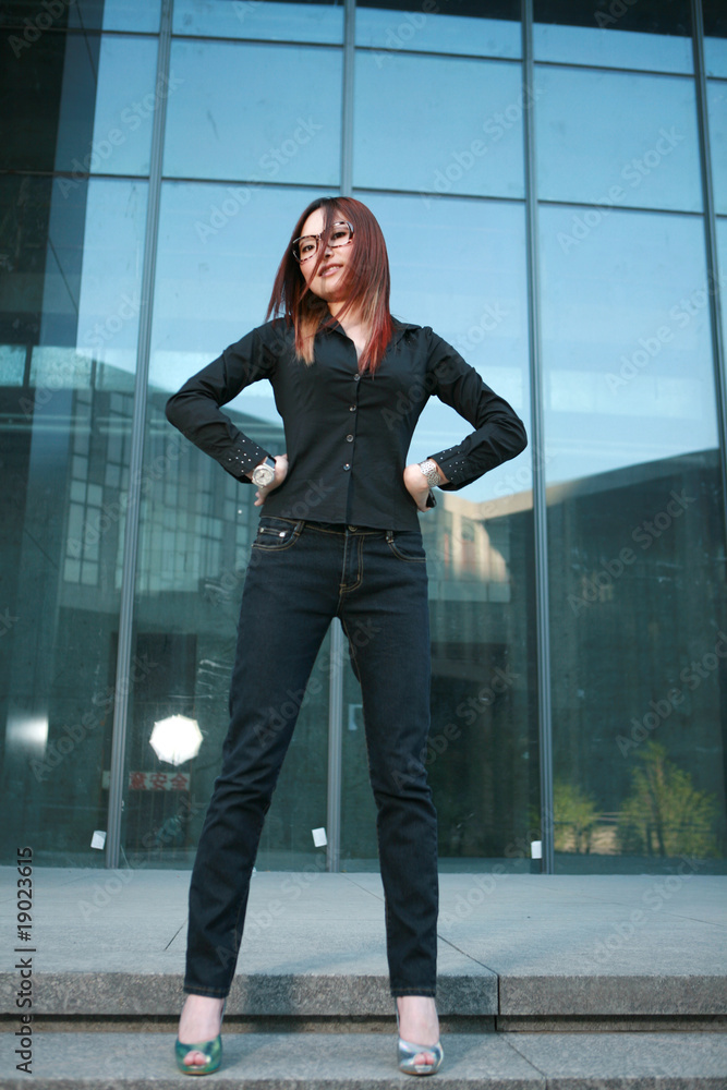 young asian businesswoman stand before office building