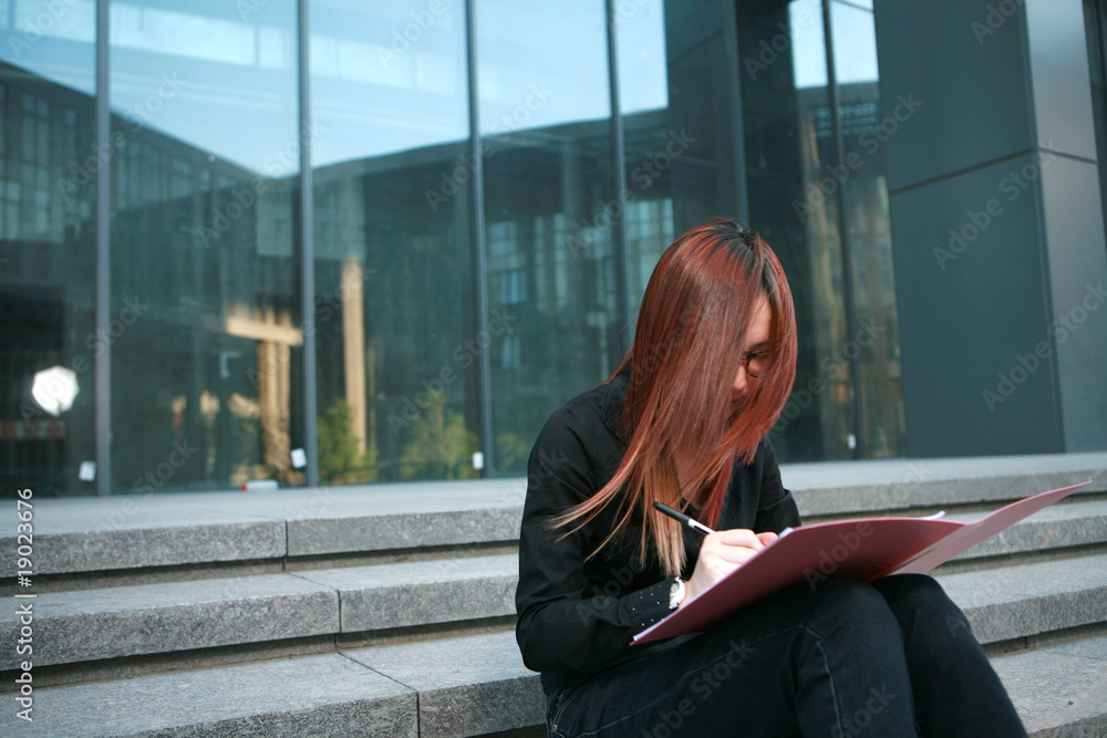 young business woman write on folder