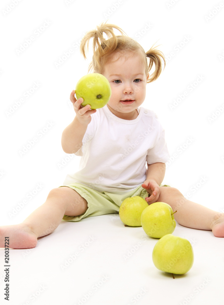 Baby girl with green apples