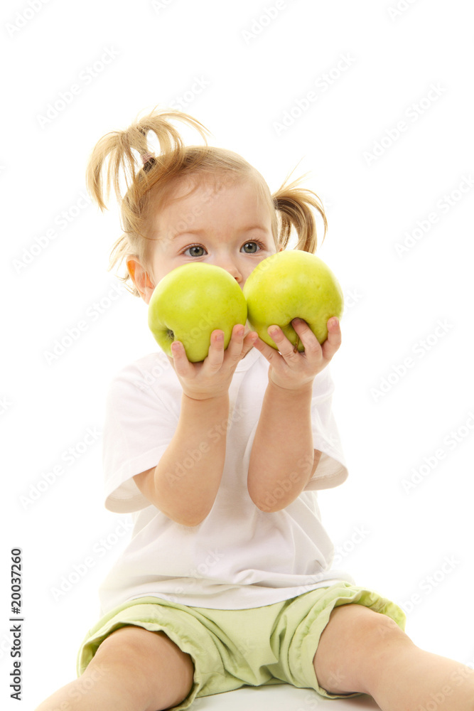 Baby girl with green apples