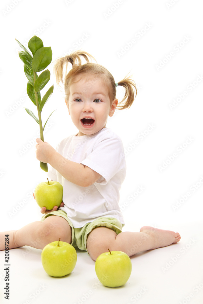 Baby girl with green apples