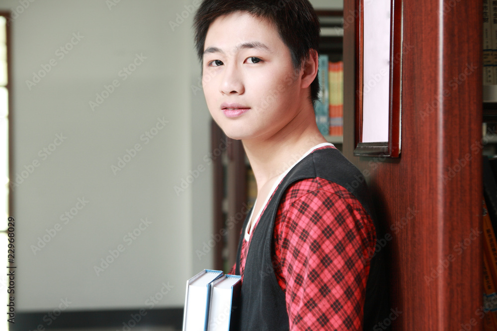 asian boy studying in library