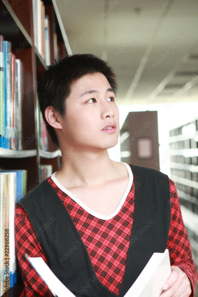 asian boy studying in library