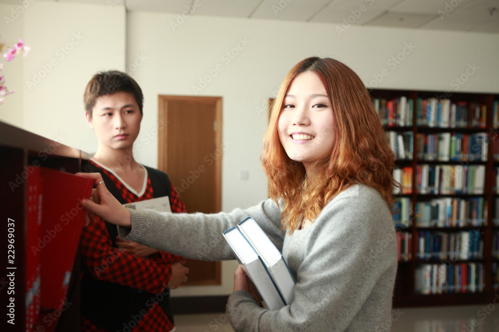 boy and girl studying in library