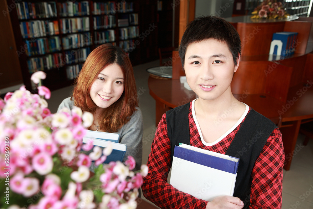 boy and girl studying in library