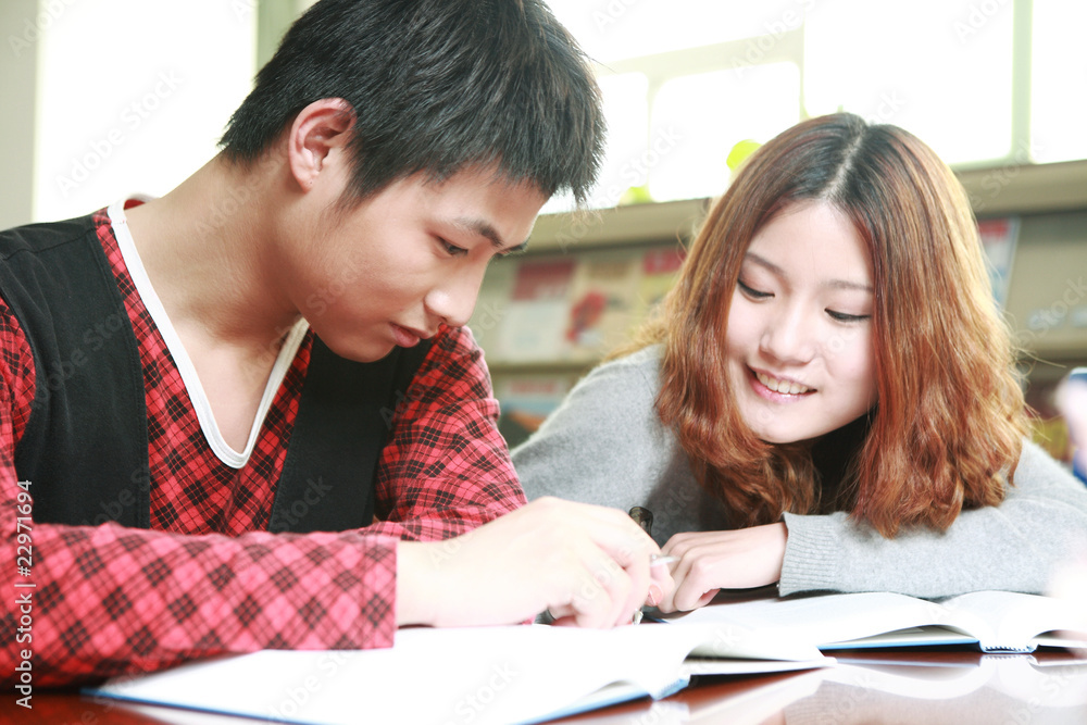 asian boy and girl studying in library