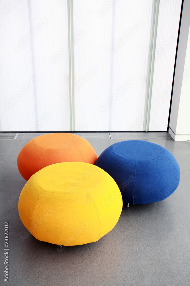 three different color rounded sofas isolated in morden house.