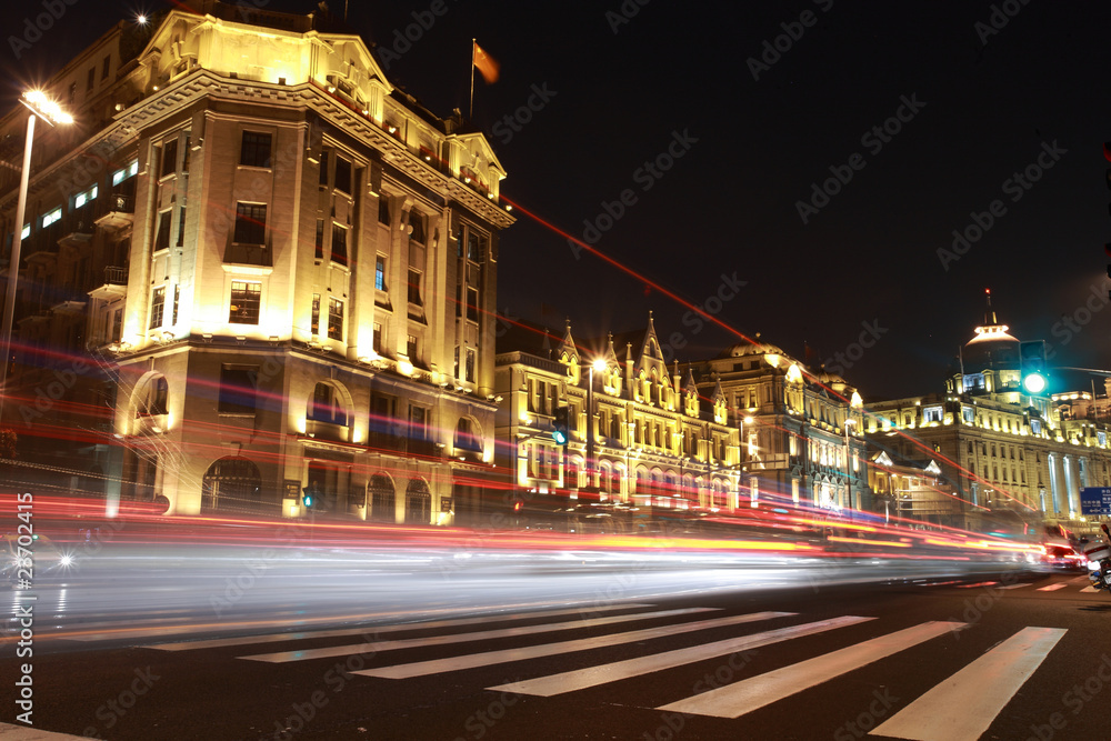 modern urban city at night with freeway traffic .