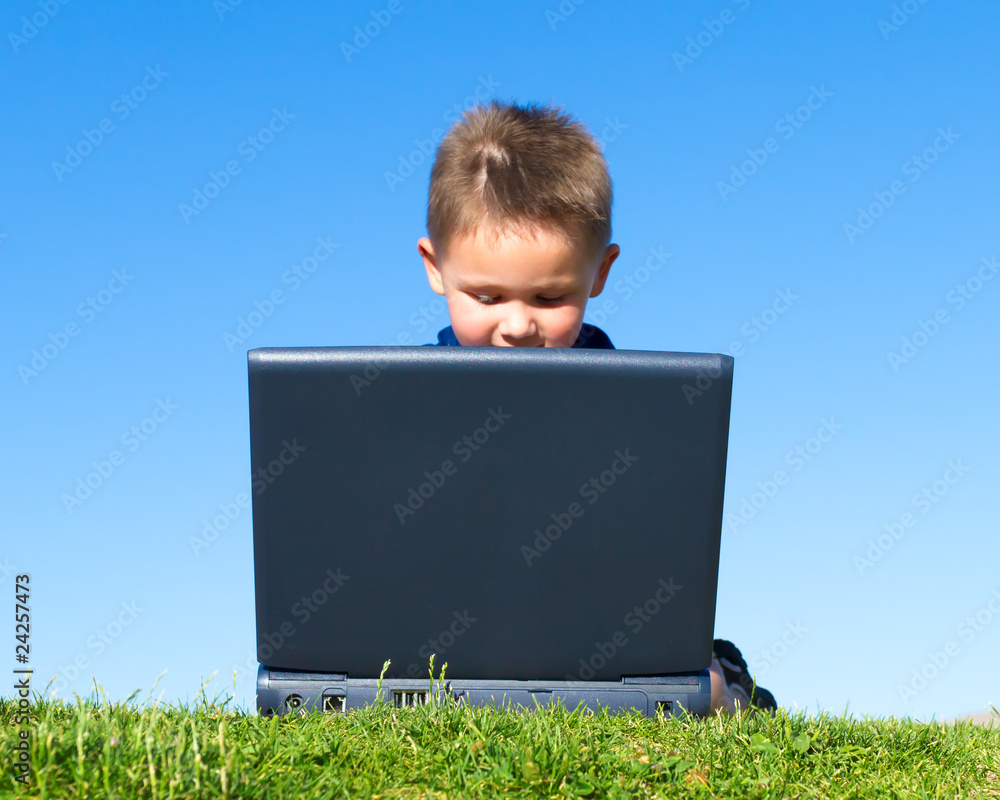 Boy playing with laptop