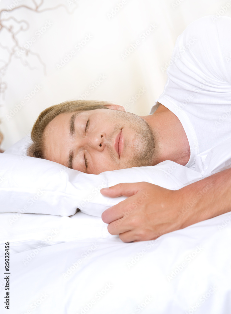 Young Man Sleeping in his Bed