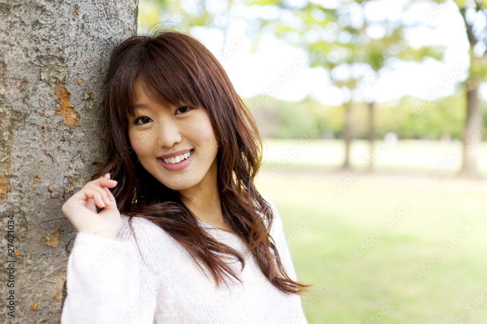 a portrait of young woman in the park