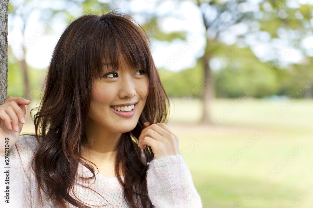 a portrait of young woman in the park