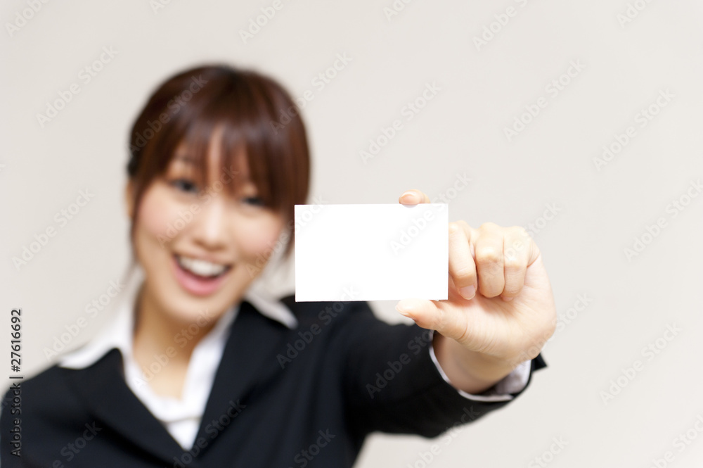 a portrait of young business woman taking a white card