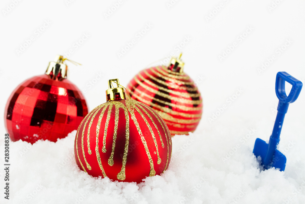 Christmas baubles on snow isolated on white