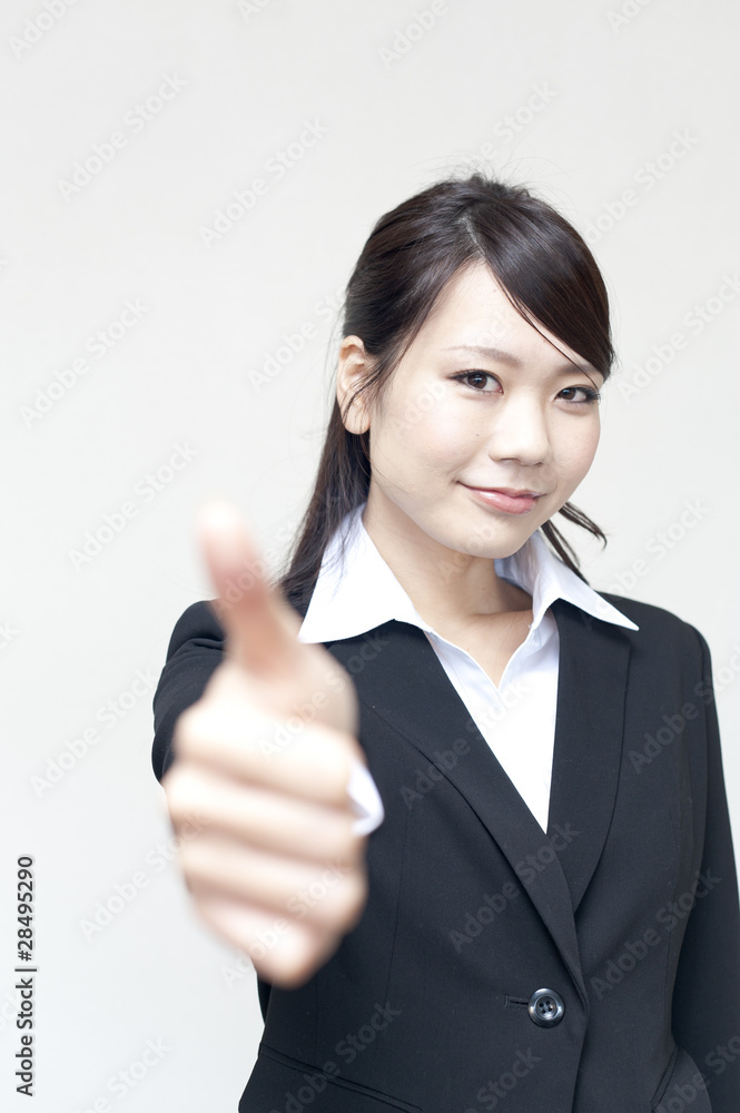 a portrait of young business woman showing thumb up