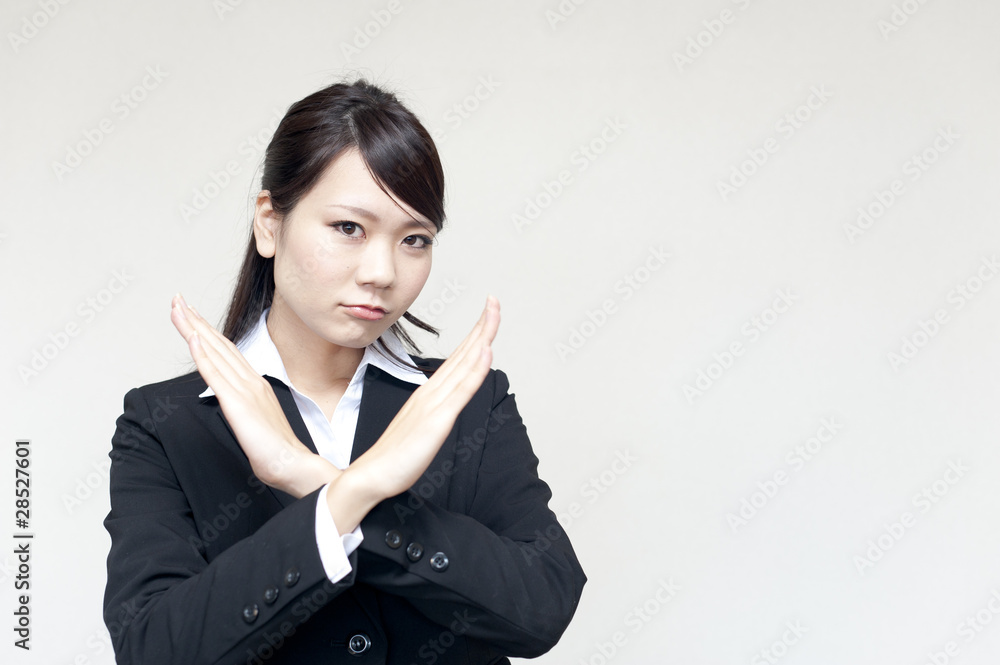 a portrait of young business woman showing x sign