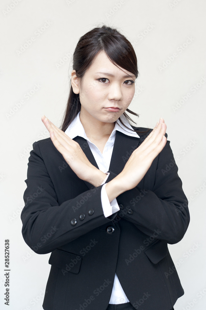 a portrait of young business woman showing x sign