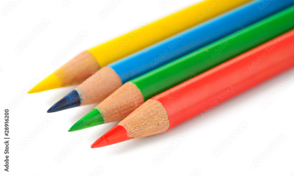 Isolated pencils. Yellow, blue, green and red pencils in a row isolated on white background