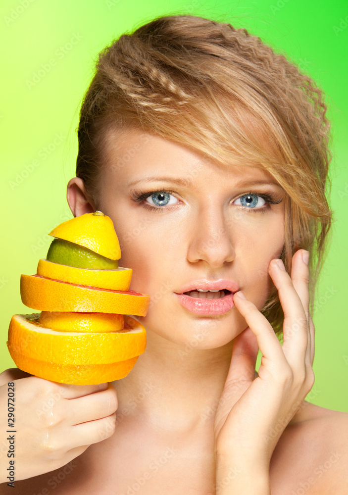 Face of beautiful woman with pyramid of fruits