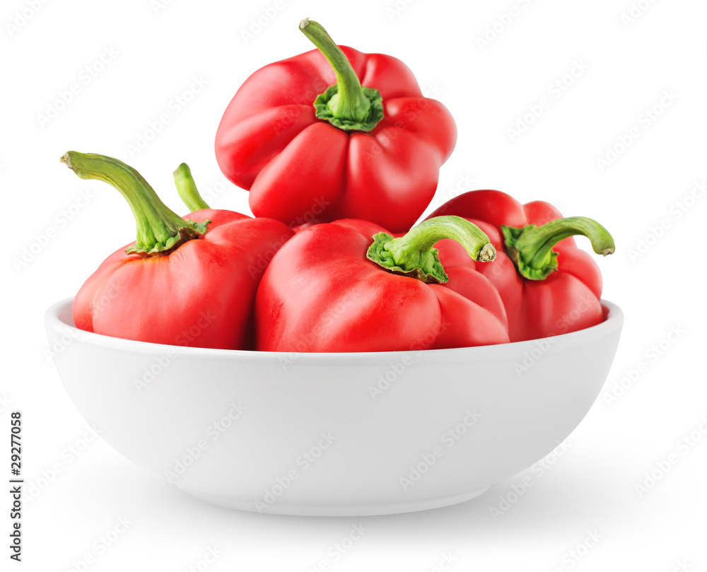 Isolated peppers. Pile of red bell peppers in a bowl isolated on white background