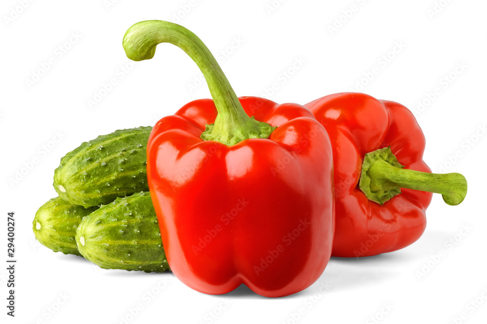 Isolated vegetables. Red bell peppers and cucumbers isolated on white background