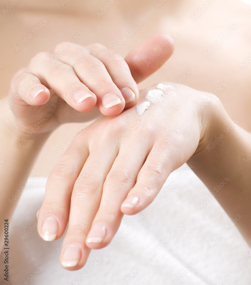 Female applying moisturizer to her Hands