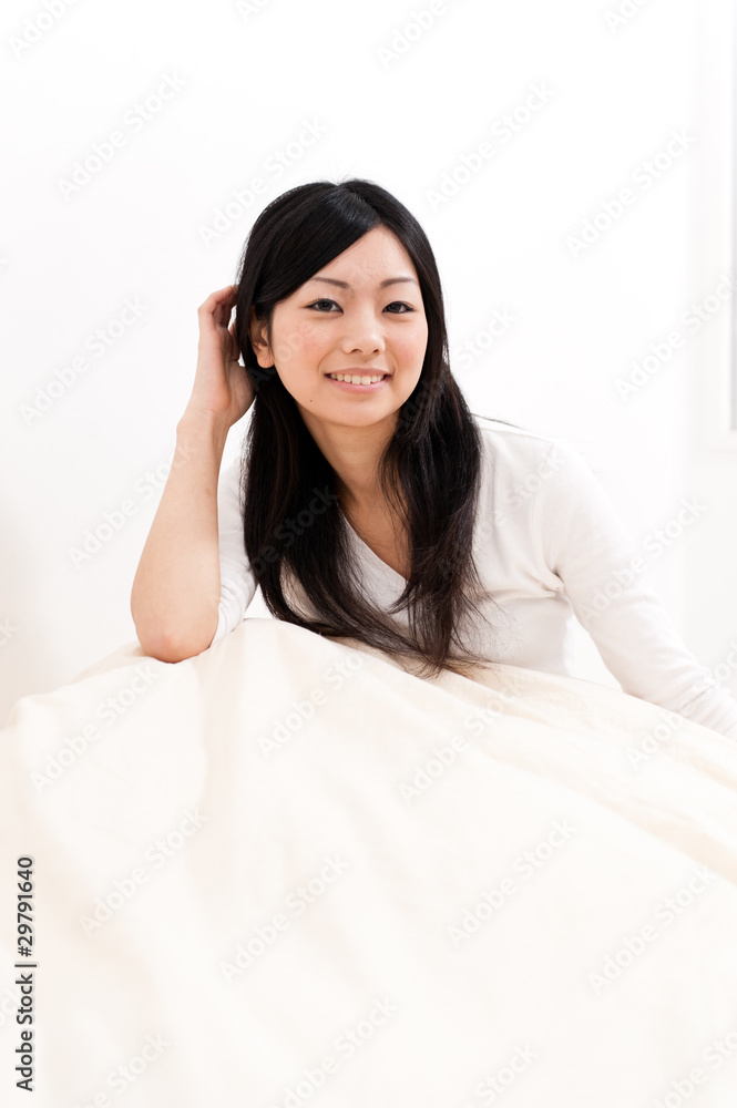 a portrait of beautiful asian woman on the bed