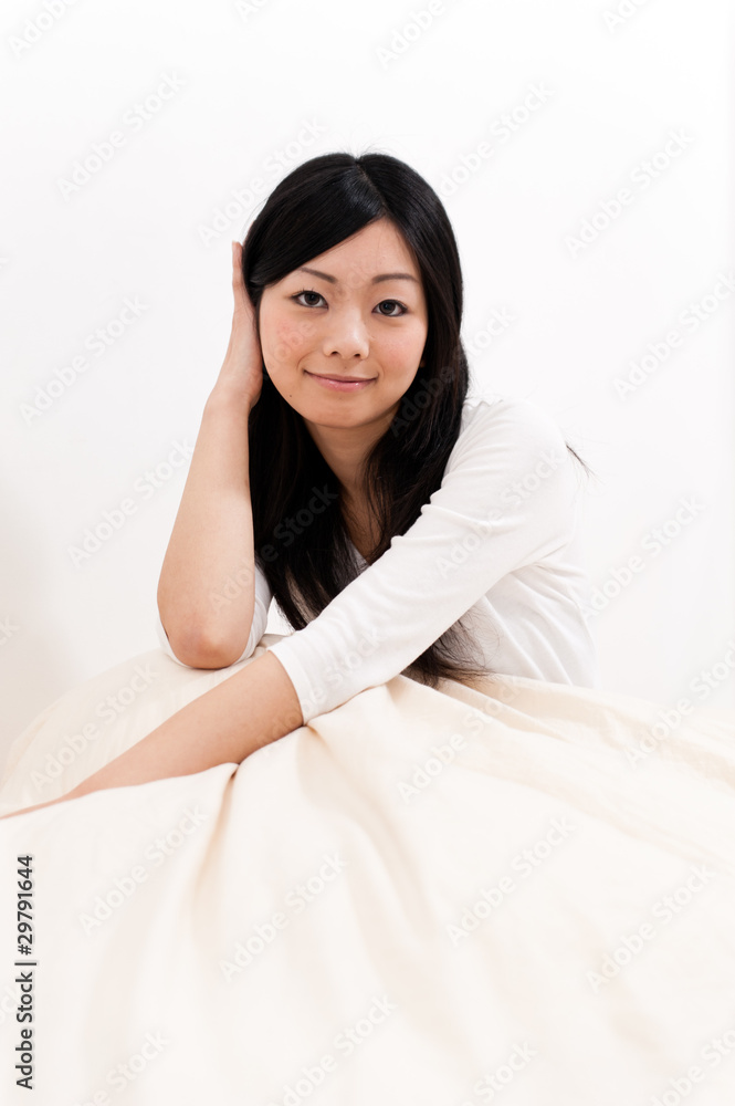 a portrait of beautiful asian woman on the bed