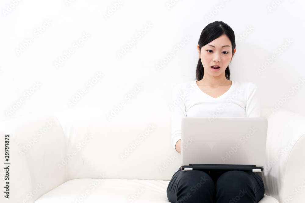 beautiful asian woman using laptop on the sofa