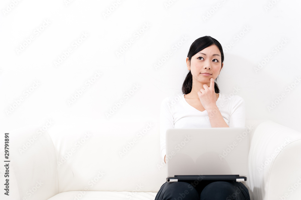 beautiful asian woman using laptop on the sofa