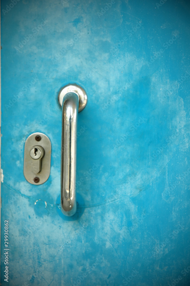 Door handles with  blue metal door .