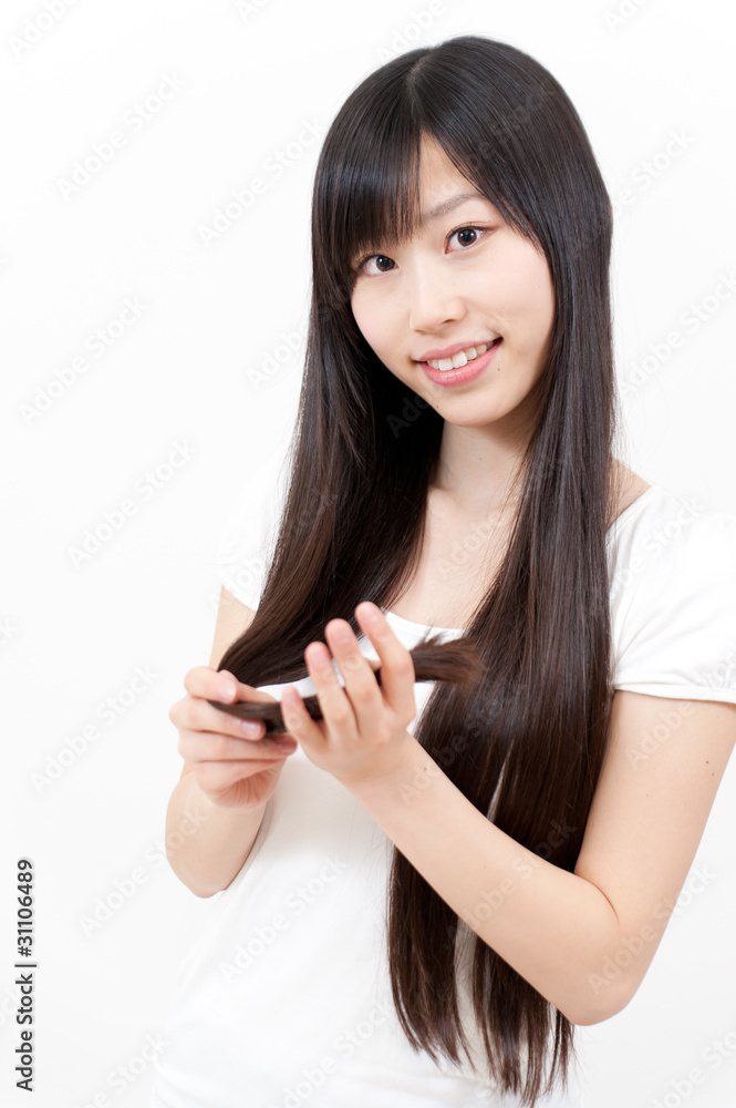 beautiful asian woman taking care of her hair