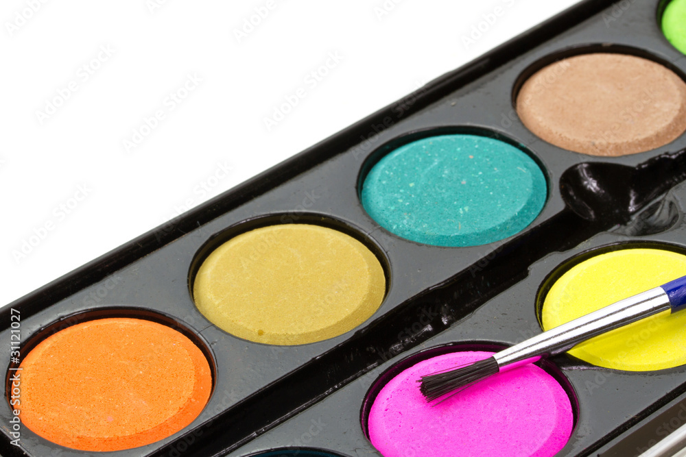 Closeup of a palette of watercolor paints with brush.