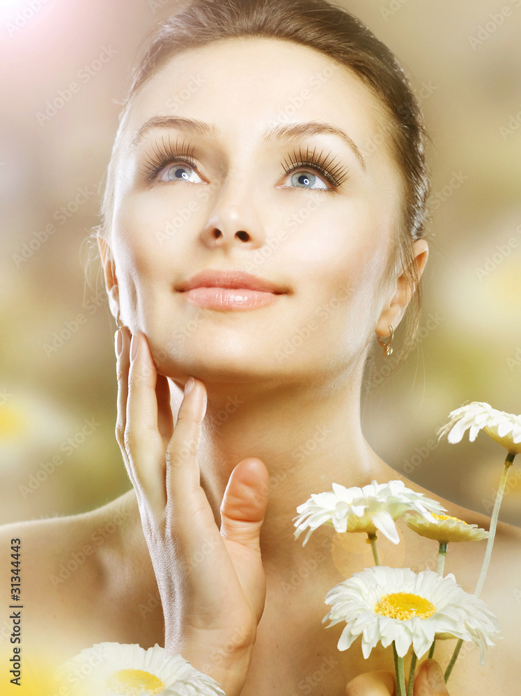 Beautiful Spring Woman with Chamomile flowers.