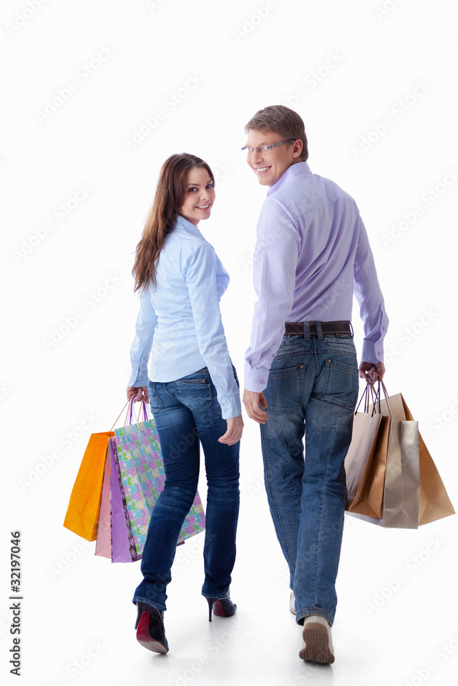 A walking couple with bags