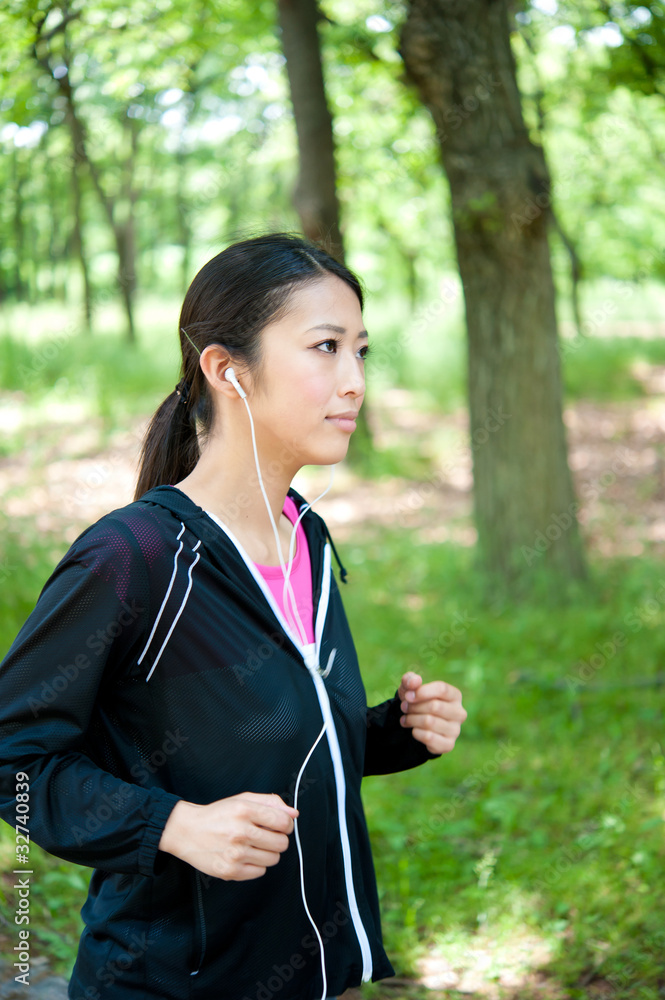 beautiful asian woman jogging in the park