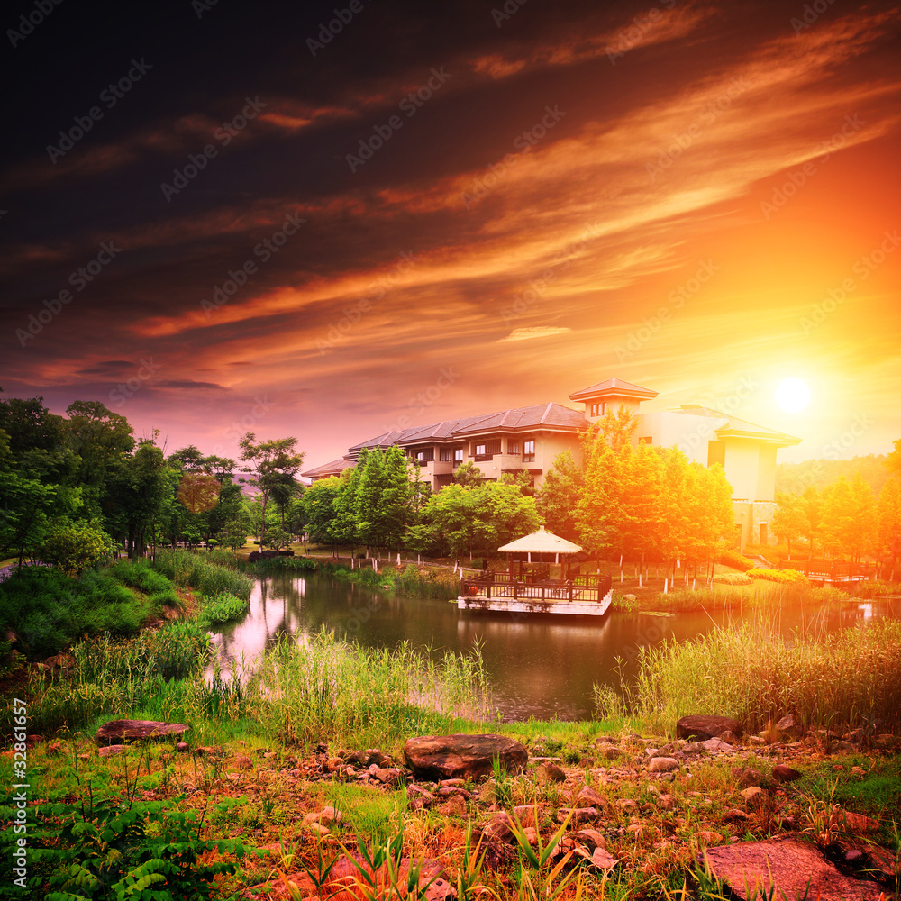 Landscape with house on lake with sunset