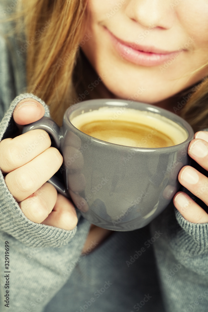 woman holding cup of coffee