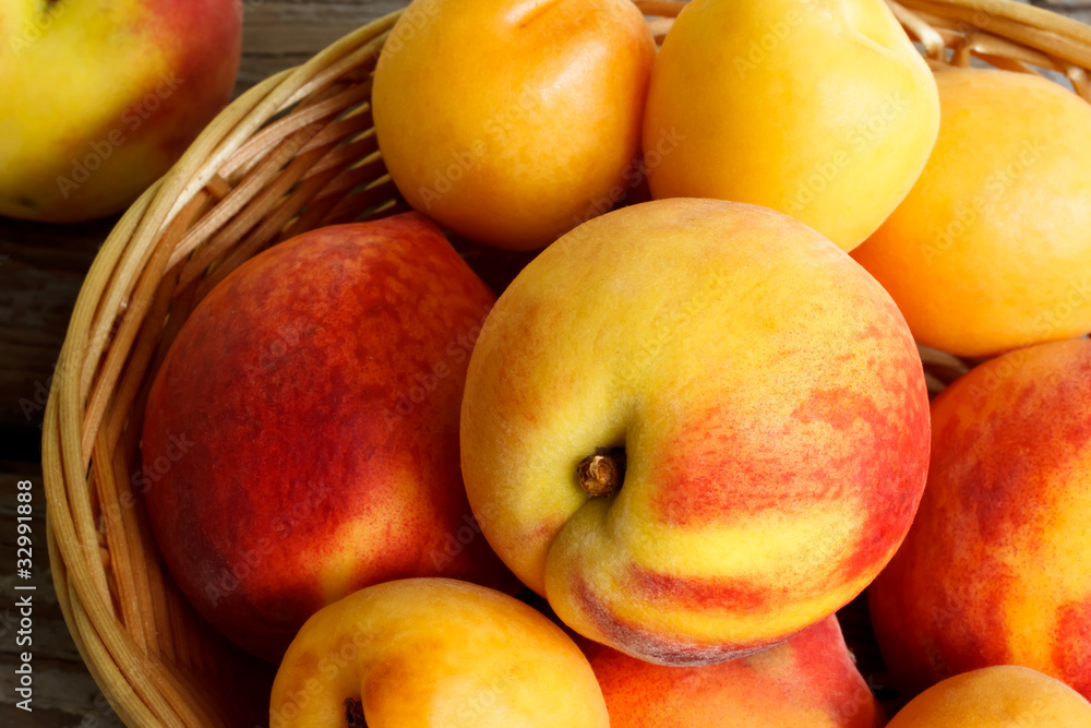 Juicy nectarines and apricots in basket