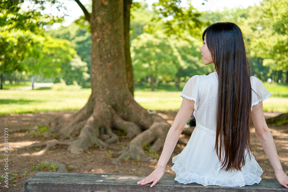 beautiful asian woman sitting on the bench