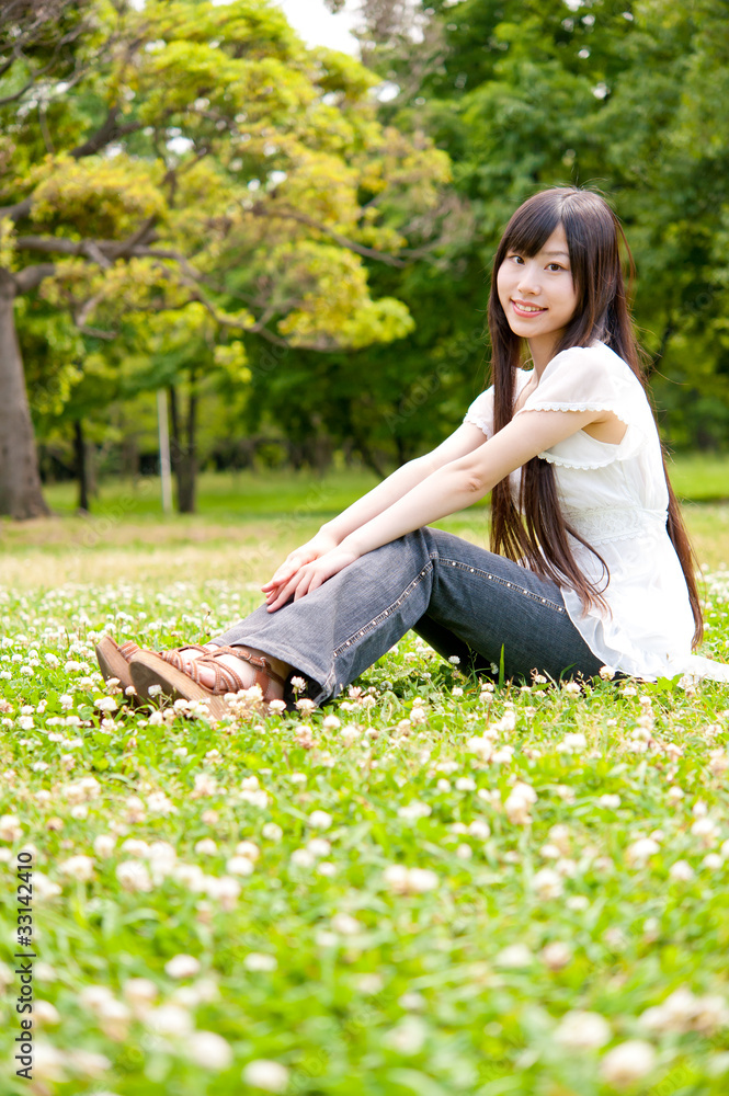 beautiful asian woman relaxing in the park