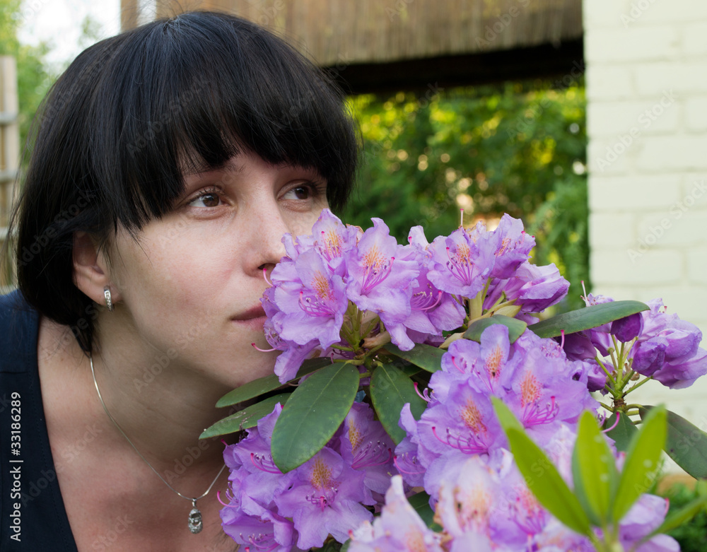 The girl smells violet flowers